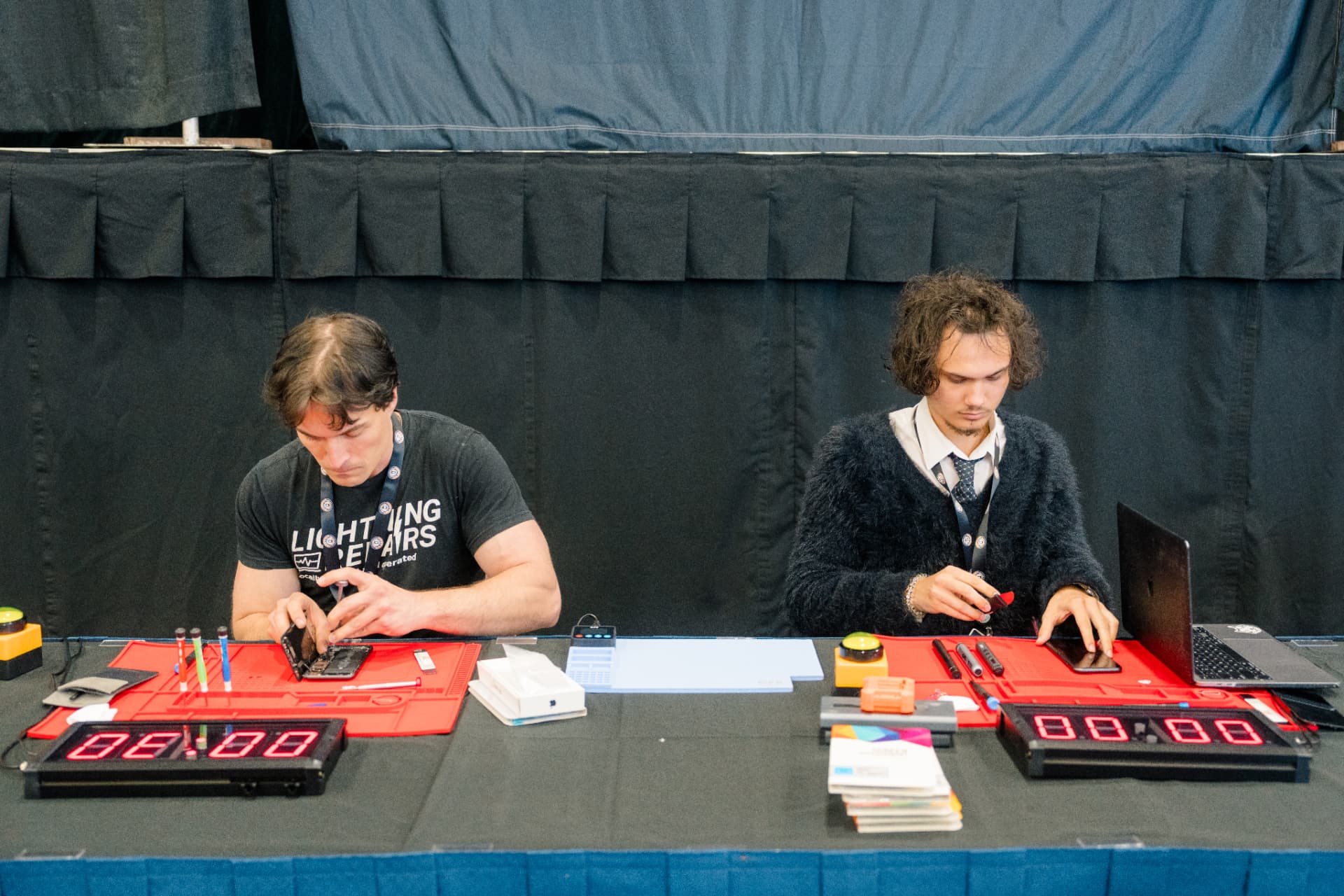Two competitors racing side by side with countdown clocks at the Music City Battle LCD Swap Competition