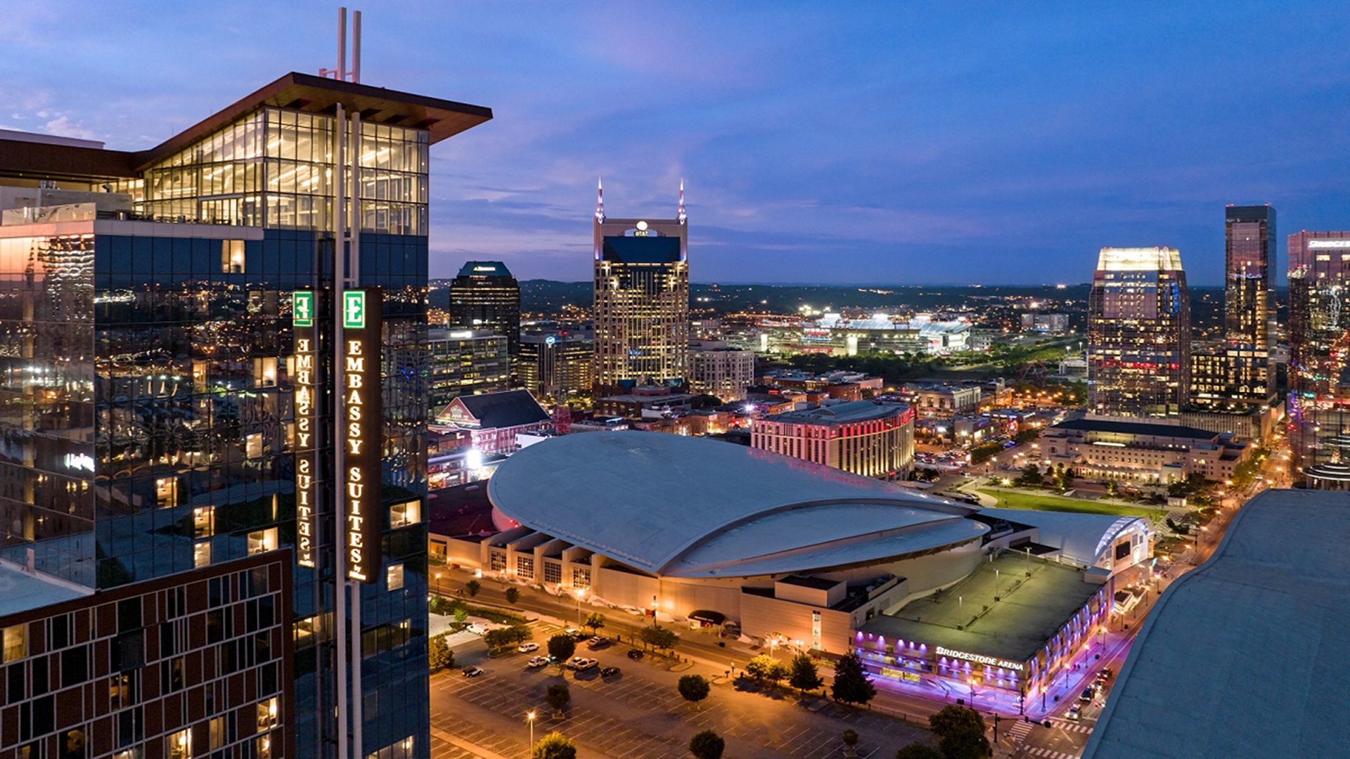 Embassy Suites by Hilton Nashville Downtown tower overlooking the Nashville skyline at dusk